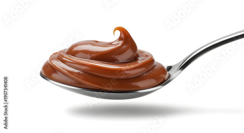 Chestnut cream on spoon isolated on white background, smooth seasonal spread with rich natural color.