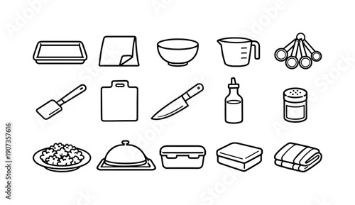 Home kale chip baking tools: baking tray, parchment paper, mixing bowl, measuring cup, measuring spoon, spatula, cutting board, chef knife, oil bottle, spice