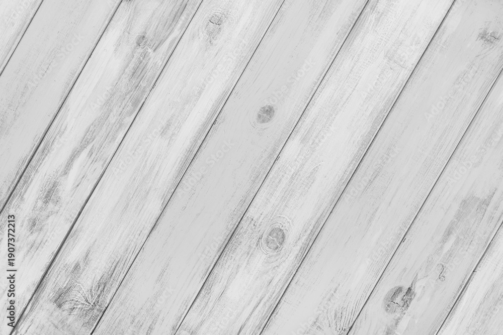 Obraz premium White colored painted wooden board with visible grain and diagonal planks, wall wooden surface. Rustic wood texture background, design element, wallpaper, backdrop