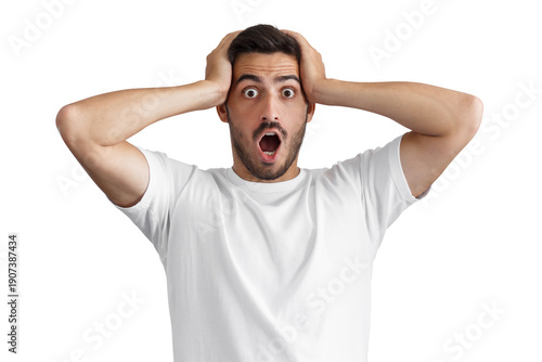 Surprised young man with mouth open and hands on head expressing shock or disbelief