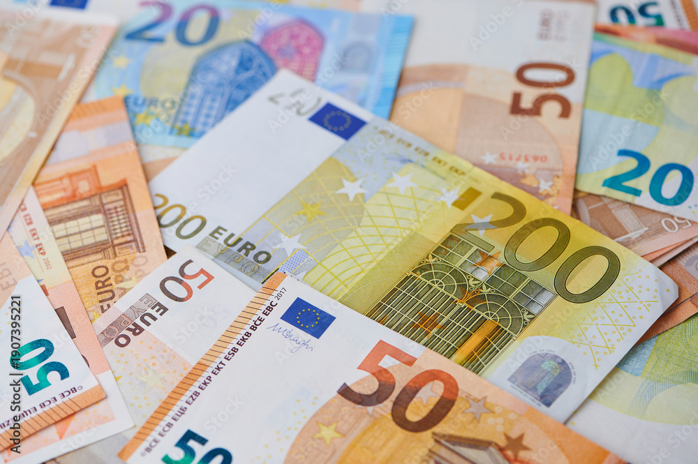 Obraz premium Various euro notes are seen together on a table.