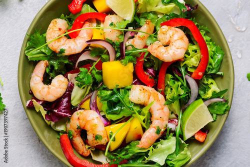 Green fresh salad with mango, shrimp and cilantro-lime dressing