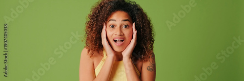 Photos The girl shows shock and pleasant surprise, got sudden news and confusion on green screen chroma key background