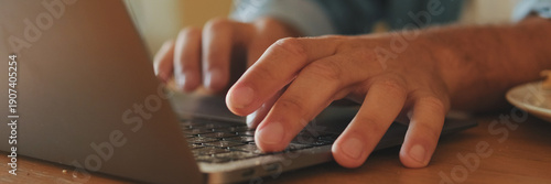 Wallpaper Mural Close-up of the hands of young unidentifiable man working on laptop. Panoramic Torontodigital.ca