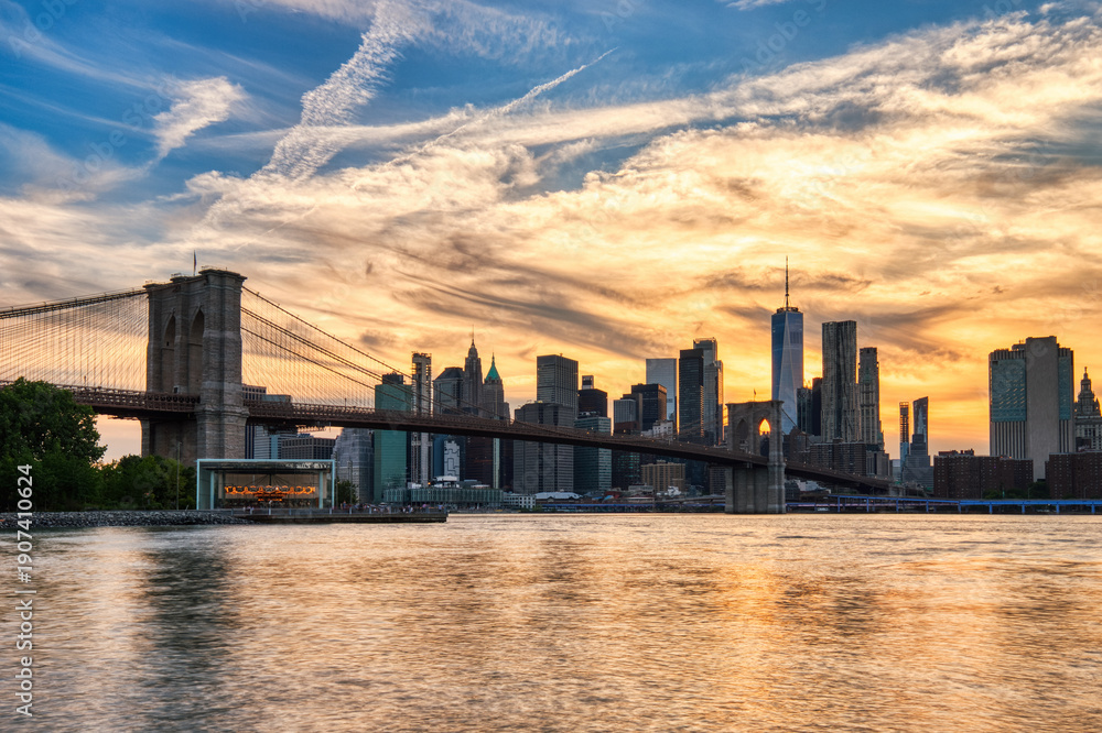 Fototapeta premium New York City Manhattan Downtown with Brooklyn Bridge at Sunset