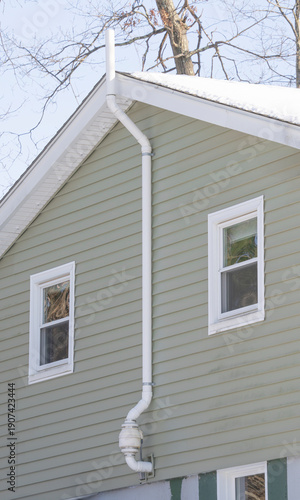 close up on house with radon mitigate system installed