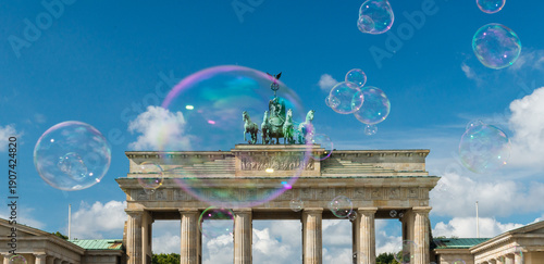 Germany, Berlin.   Large soap bubbles floating above the Brandenberg Gate. 