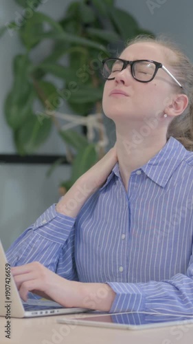 Young Woman with Neck Pain Working on Laptop, vertical video