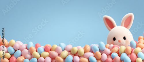 Cute bunny peeking over colorful Easter eggs on blue background with copy space