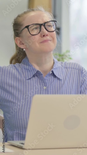 Young Woman with Back Pain Working on Laptop, vertical video