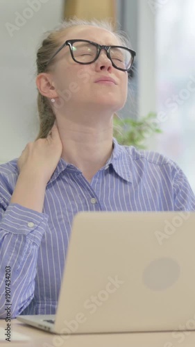 Young Woman with Neck Pain Working on Laptop, vertical video