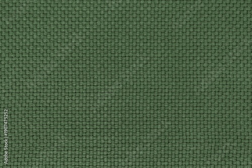 Detailed texture of deep green woven fabric background. Top view of olive forest green colored thick throw blanket material with a basket weave pattern