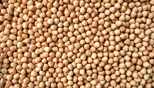A close-up view of numerous chickpeas spread out on a surface.