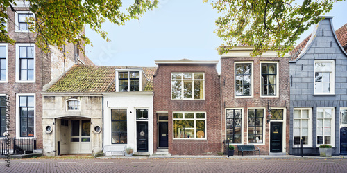 Authentic facade of historic houses in Zierikzee, Netherlands. Featuring diverse architectural styles, brickwork, and traditional Dutch gables
