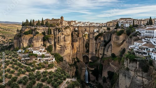 Wallpaper Mural Scenic view of a historic city built on cliffs with lush greenery and traditional architecture under a clear blue sky. Torontodigital.ca