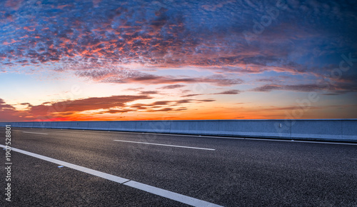 Wallpaper Mural Empty asphalt highway with white lane markings under a vibrant sunset sky Torontodigital.ca