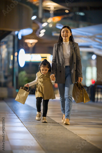 mother and child girl wolking with shopping bag and sightseeing in Bangkok city at night