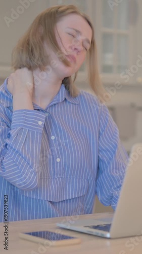Young Woman with Neck Pain Working on Laptop