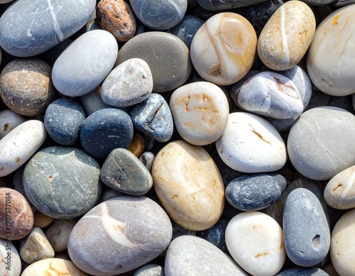 Close-up of a diverse collection of smooth, colorful river rocks and pebbles, natural textures.