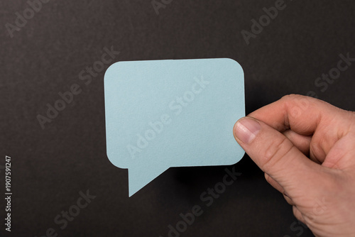 Hand holding a light blue s...