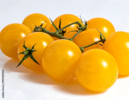 Wallpaper Mural Close-up of a vibrant yellow tomato cluster, with smooth, round fruits, and green stems, on a reflective surface Torontodigital.ca