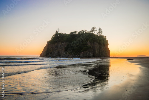 Ruby Beach at dusk in Olympic National Park, Washington. Vibrant sunset colors, coastal rocks, and ocean waves create a serene wilderness scene.