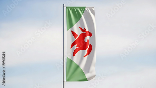 Flag featuring a red and white emblem on a green and white background waving in the wind