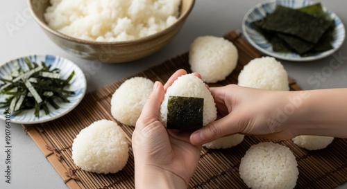 Handmade Onigiri Preparation with Seaweed and Rice Balls on Bamboo Mat Asian Cuisine Concept