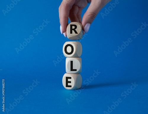 Role symbol. Concept word Role on wooden cubes. Businessman hand. Beautiful blue background. Business and Role concept. Copy space.