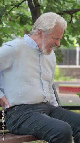 Senior Old Man Sitting Outdoor with Back Pain, vertical video