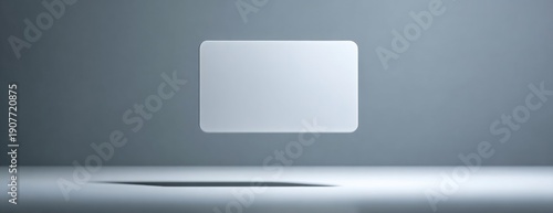 Blank white credit card mockup floating on simple gray background  