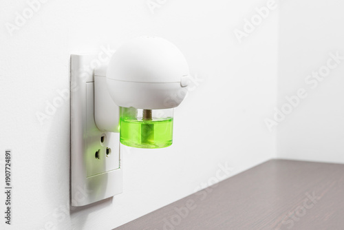 Wallpaper Mural Electric device with liquid mosquito repellent into wall socket Torontodigital.ca