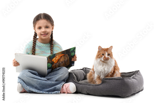 Cute little girl reading bo...