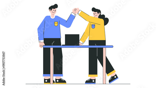 Two business colleagues giving a high five over a desk to celebrate a successful project