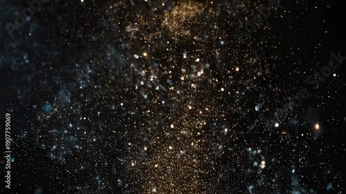 Abstract image of floating, glittering particles, illuminated against a dark background