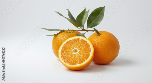 Fresh Whole and Sliced Oranges with Green Leaves on a Minimalist White Background - High Quality Cinematic Citrus Fruit Still Life