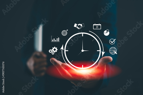 Valokuva A person holding a glowing digital clock surrounded by virtual business icons symbolizing time management and productivity