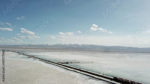 Train Crossing Chaka Salt Lake Flats with Mountain Views
