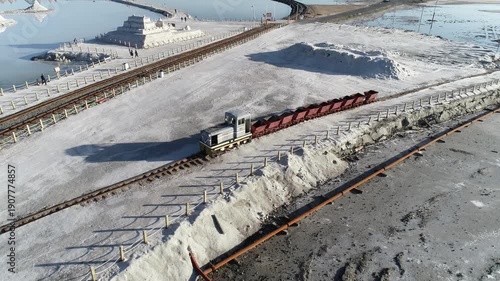 Freight Train Hauling Cargo at Great Salt Lake Aerial View