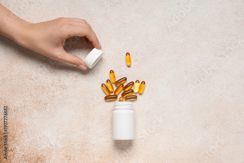 Female hand with jar of vit...