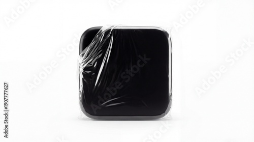 Black Square Object Wrapped in Plastic on White Background.