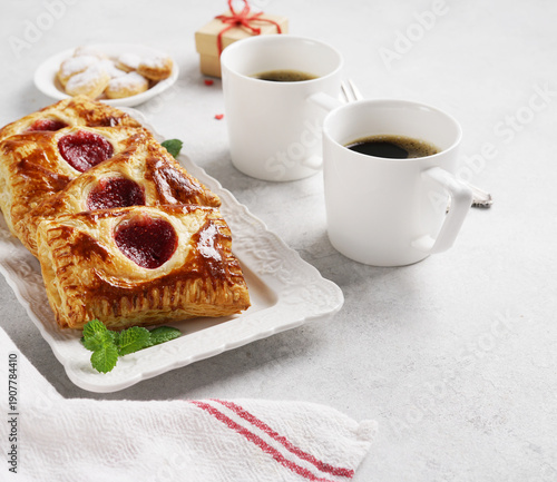 Pastry Envelopes with jam filling decorated with hearts on white background. Dessert for Valentine day.