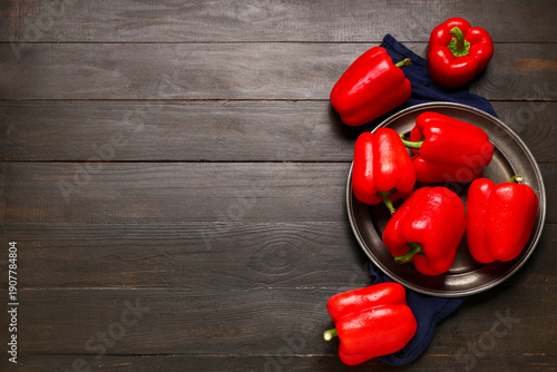 Fotografie Plate with red bell peppers on wooden background
