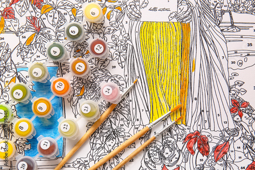 Paints and brushes on unfin...
