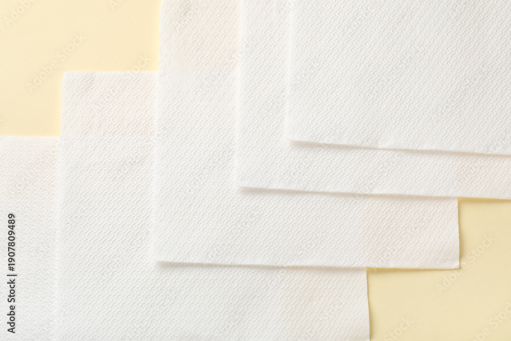 Fototapeta premium Row of paper napkins on beige background