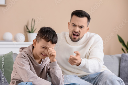 Crying boy with his father ...