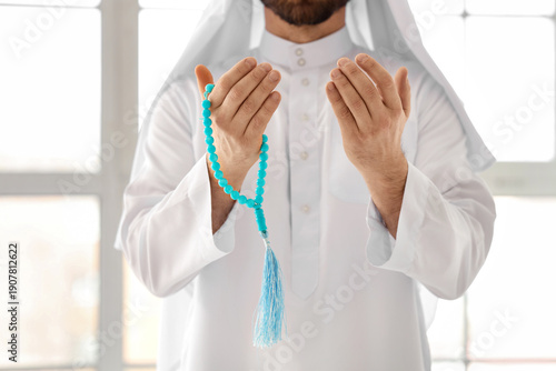 Muslim man with tasbih pray...