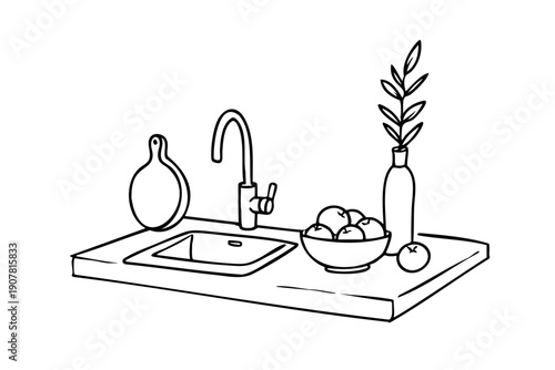 Sink is on a counter with a bowl of fruit and a vase. The sink is white and the bowl is red. The fruit is apples and oranges. The vase is green and has a leaf on it