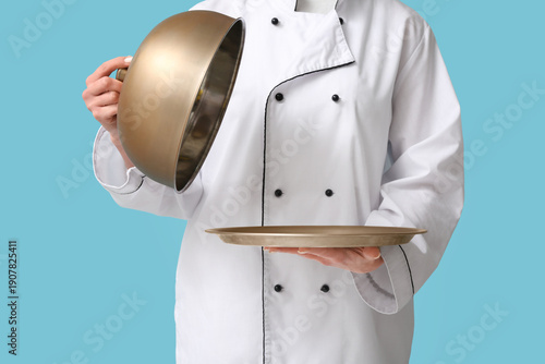 Female chef with metal tray...