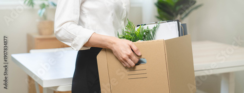 Photos unemployed concept, employee clear her stuff at office to move out after get layoff from company in recession
